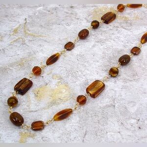 Brown glass bead necklace with a mix of shapes and all hand linked together New